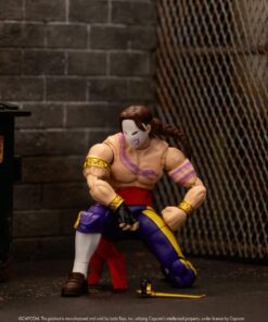 Figura de Vega arrodillado con la máscara y la garra en el suelo